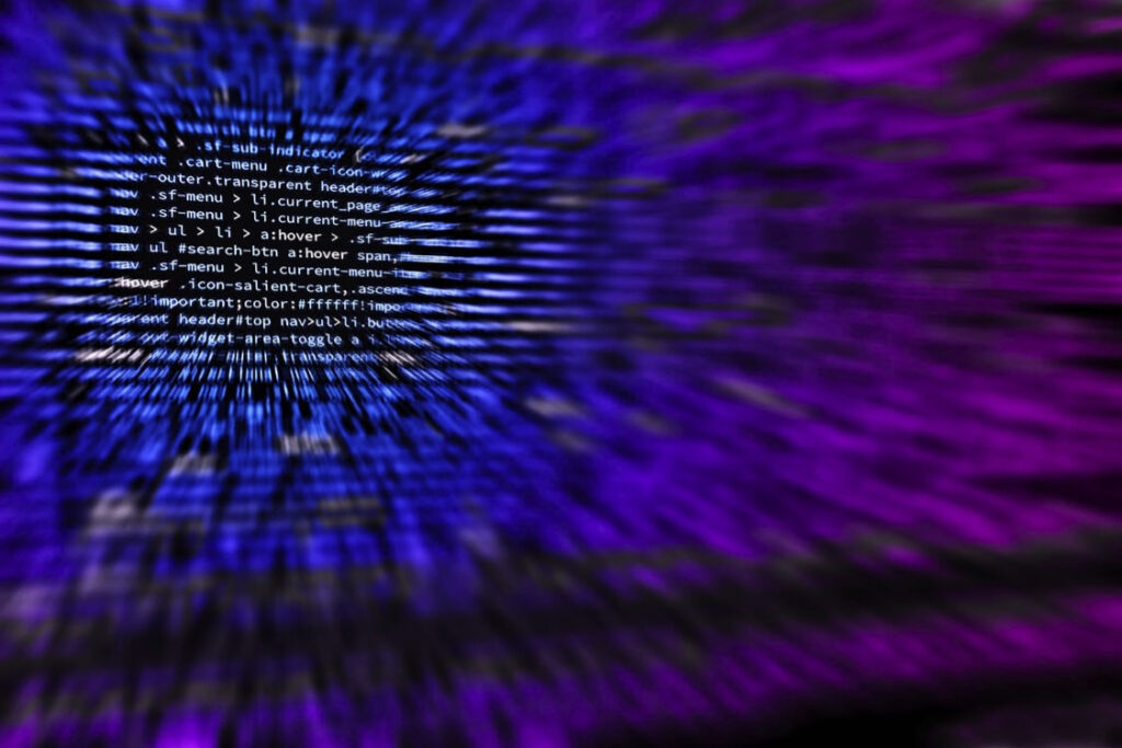 "Blurred lines of code in a dynamic, blue and purple digital background, representing programming, technology, and cybersecurity themes."