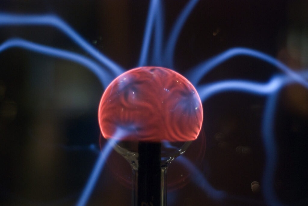 "Plasma globe with glowing electric strands, illustrating physics