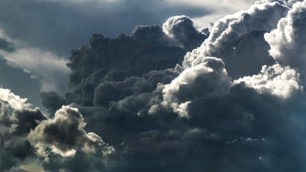 Dramatic dark storm clouds in the sky, capturing the power of nature and weather changes.