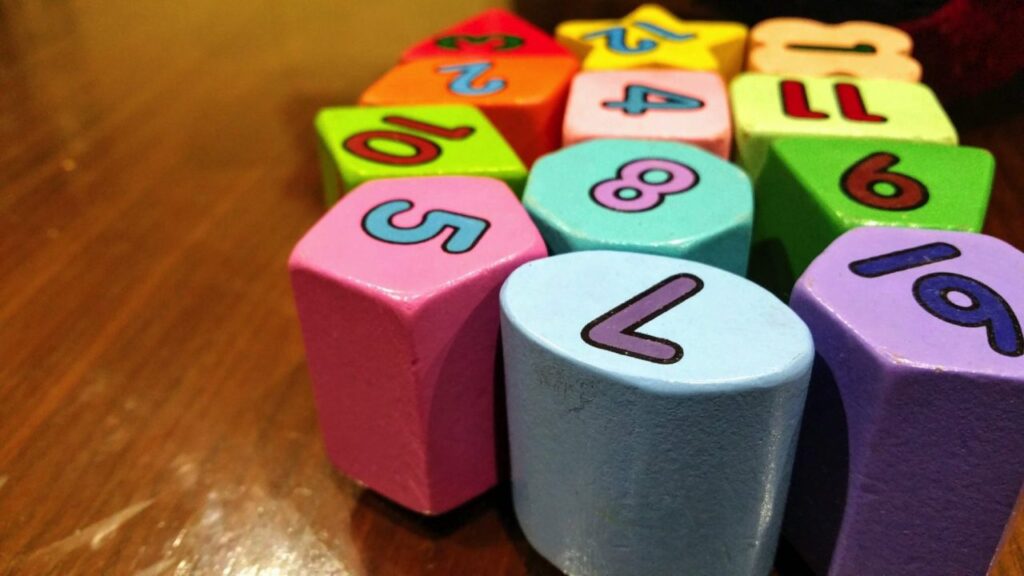 "Colorful educational wooden blocks with numbers on a table, ideal for children's learning and play activities."