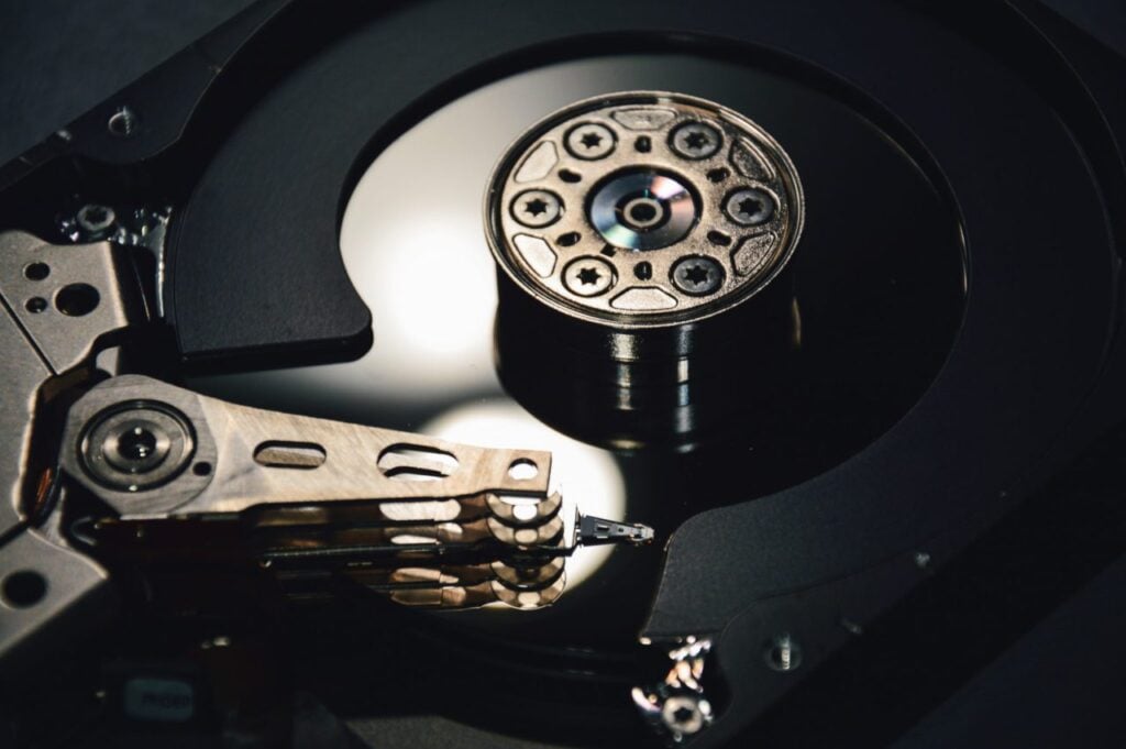 Close-up of an open hard disk drive (HDD) showing the platters and read/write arm, illustrating computer data storage technology.