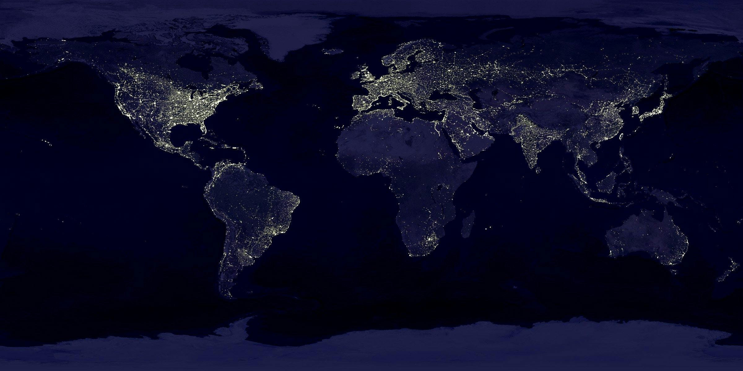 Satellite view of Earth at night showing illuminated cities and global population density