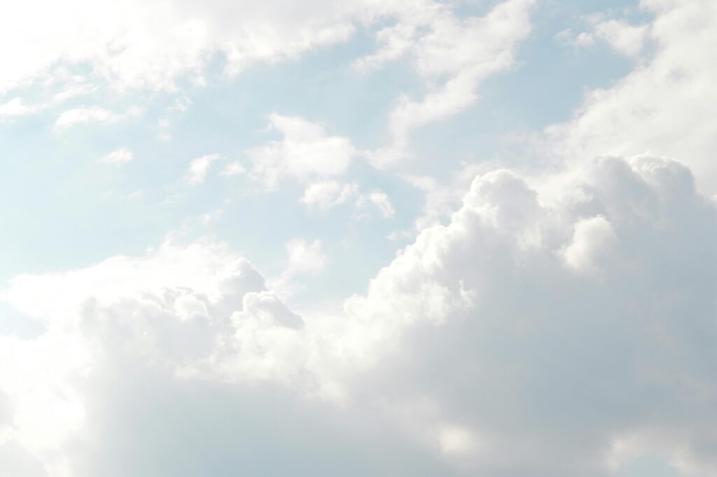 A serene view of thick, fluffy clouds set against a bright blue sky, perfect for backgrounds.